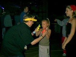 James shows the little girl who was selling all of the bracelets at the door how 'glowsticks work.'